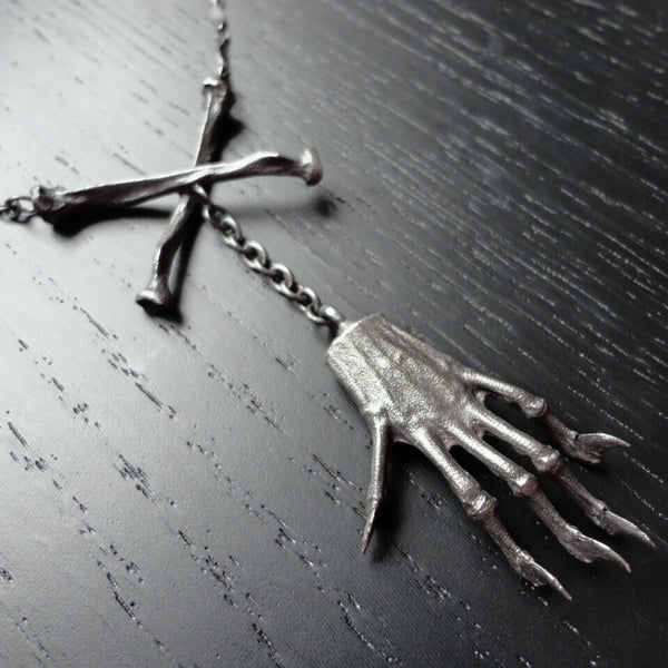 Witches Brew necklace with squirrel claw and crossbones