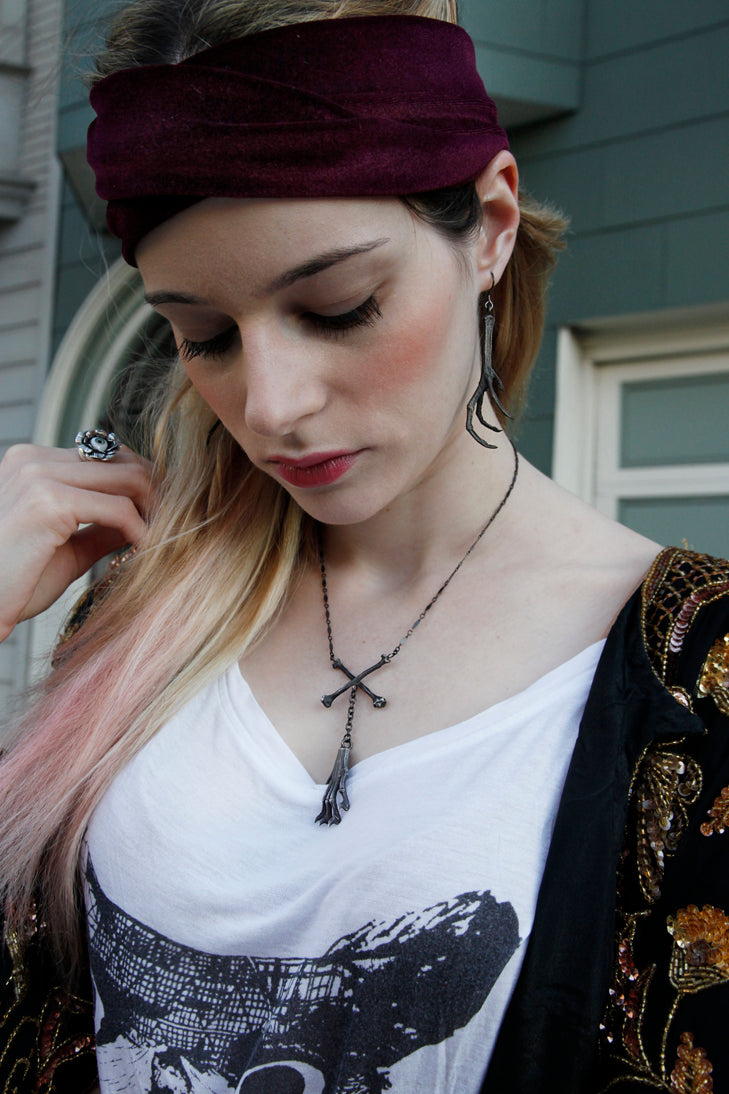 Witches Brew necklace with squirrel claw and crossbones worn by severine arend