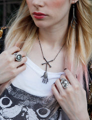 Witches Brew necklace with squirrel claw and crossbones worn by severine arend